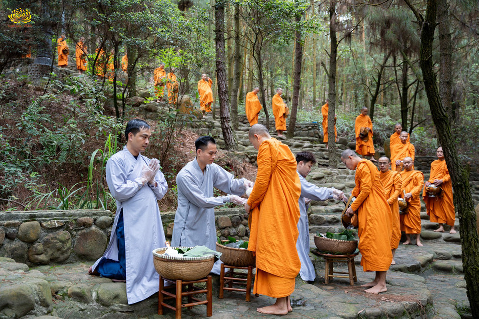 Phật tử đặt bát cúng dường thực phẩm lên chư Tăng đang thực hành 13 pháp đầu đà  