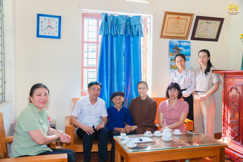 Cô Phạm Thị Yến cùng các Phật tử trong CLB Cúc Vàng và đại diện chính quyền TP.Uông Bí chụp hình lưu niệm bên mẹ Việt Nam anh hùng Hoàng Thị Nghi.