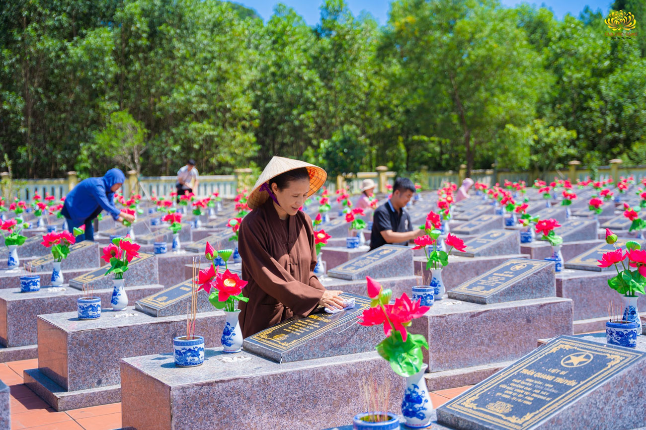 Cô Phạm Thị Yến và các Phật tử trong CLB Cúc Vàng cẩn thận làm sạch từng bia mộ các anh hùng liệt sĩ trong nghĩa trang.